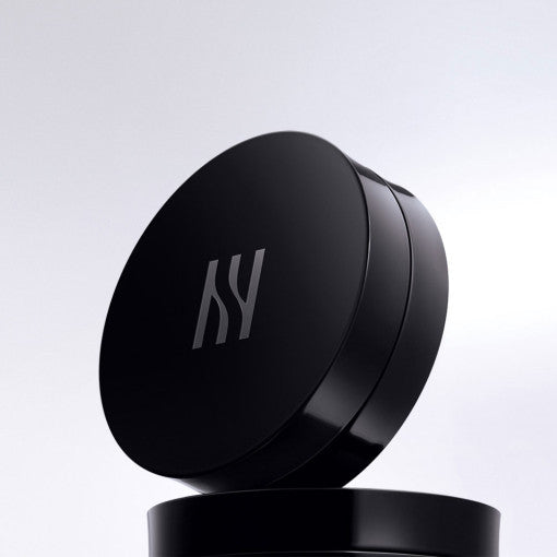 HERA Black Cushion Foundation open compact showing cushion insert and puff